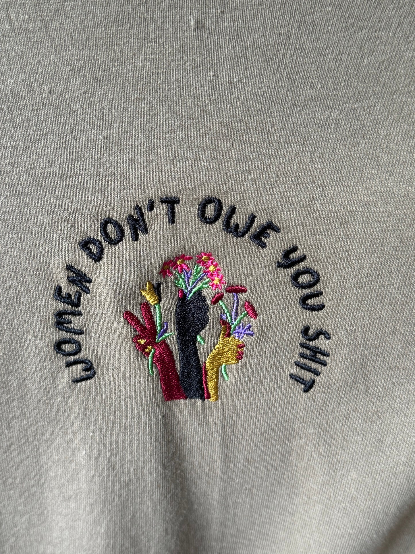 Women don't owe you shit Embroidered Women’s micro-rib tank top